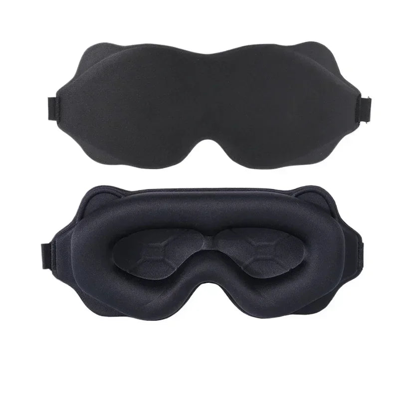 "3D contoured sleep mask with a lightweight, ergonomic design that curves around the eyes, providing a comfortable fit without pressure on the eyelids. The mask features soft, breathable fabric in a matte black finish, with adjustable straps for a secure fit. Its contoured shape allows for complete darkness while ensuring comfort, ideal for restful, uninterrupted sleep.